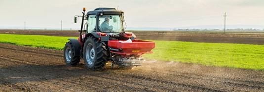 Farmer fertilises a field